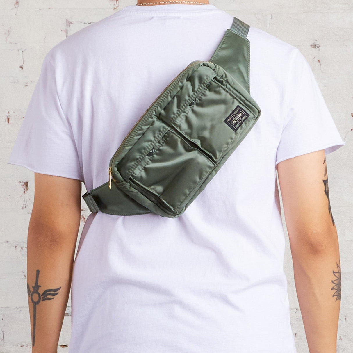 Porter Japan Tanker waist bag in sage green with adjustable strap and multiple compartments, made of durable textile material.