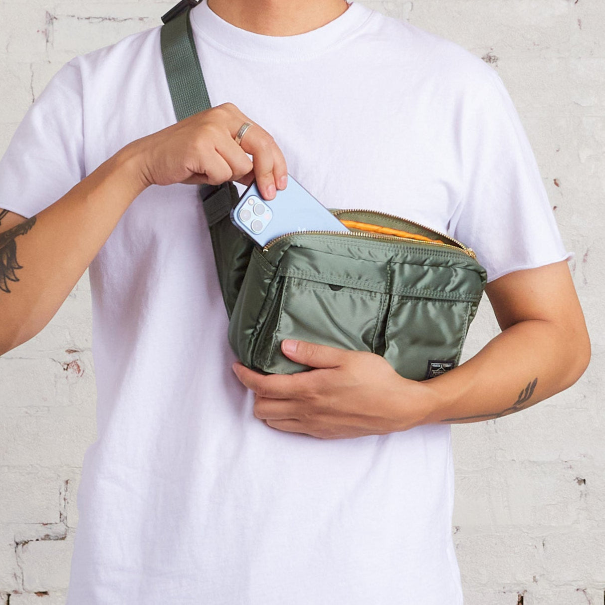 Porter Japan Tanker waist bag in sage green with adjustable strap and multiple compartments, durable and stylish for everyday use.