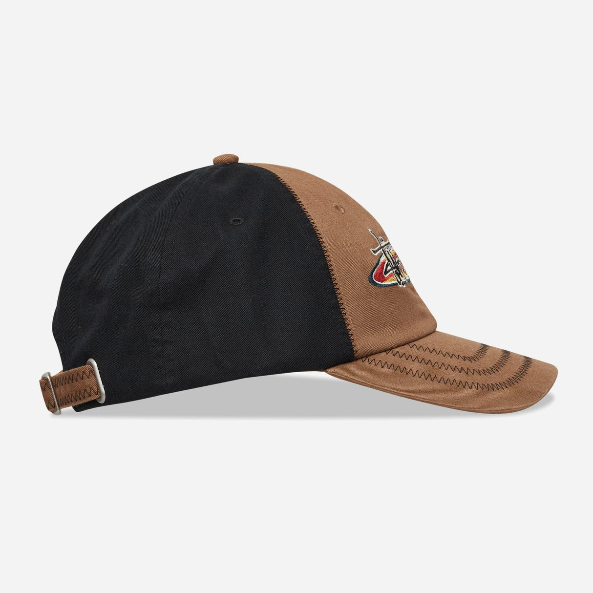 Brown Stussy oval star cap, stylish headwear with embroidered star logo, featuring a classic curved brim and adjustable strap.