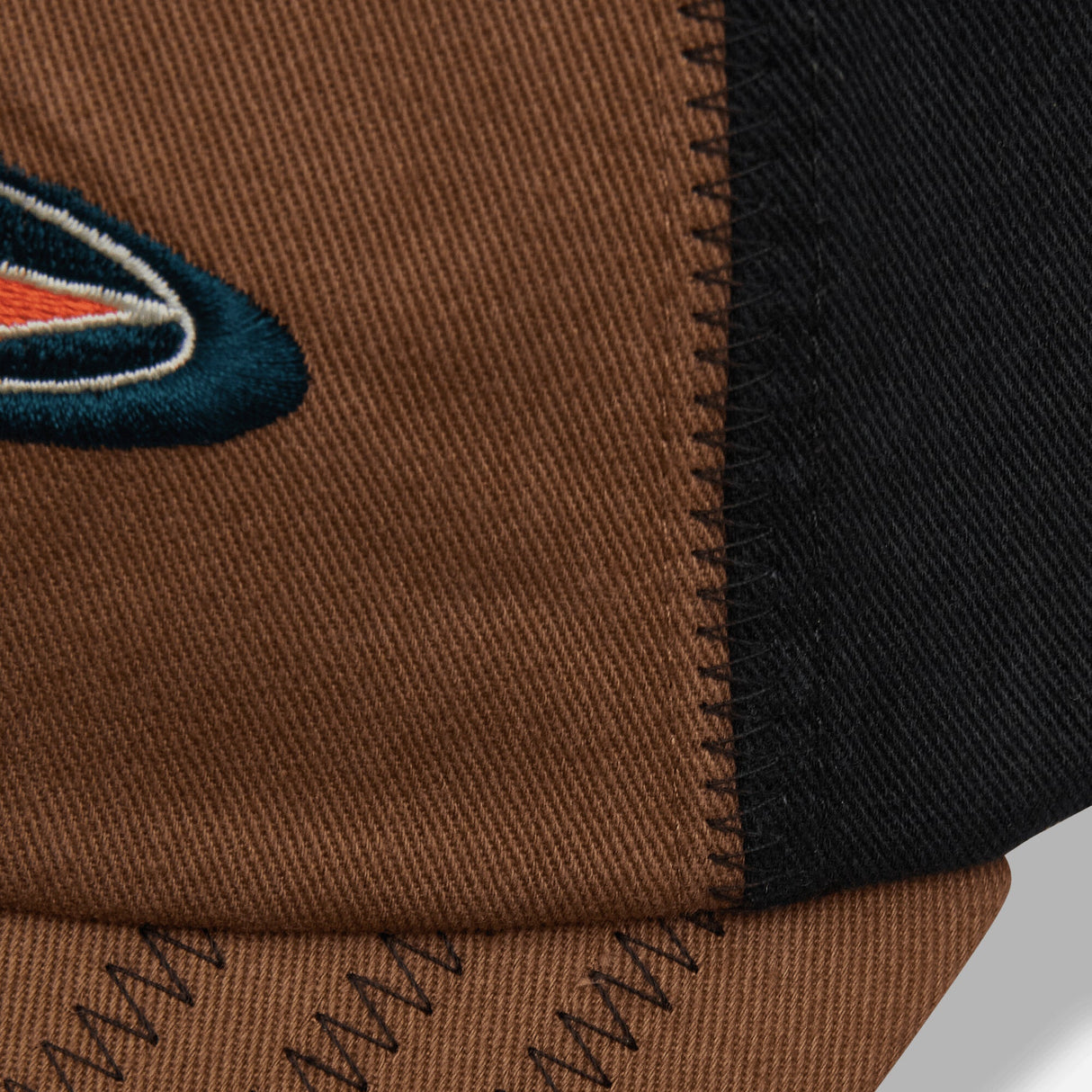 Brown Stussy Oval Star Cap, stylish headwear with embroidered star logo, showcasing a casual streetwear look.