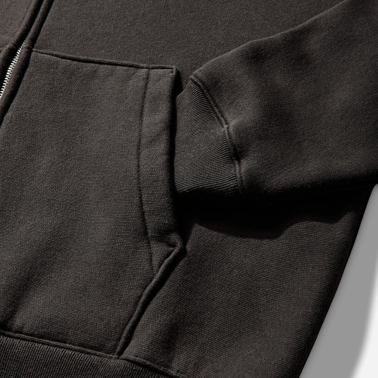 Black Stussy Diamond Logo Zip Hoodie, casual apparel with front zipper and signature logo, displayed on a hanger.