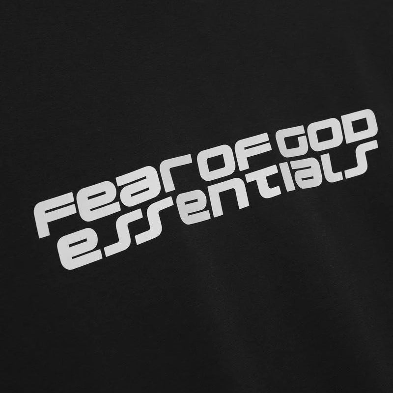 Black Fear of God Essentials Reflective Logo 90s Tee, casual t-shirt with reflective logo design, front view showing fit and style.
