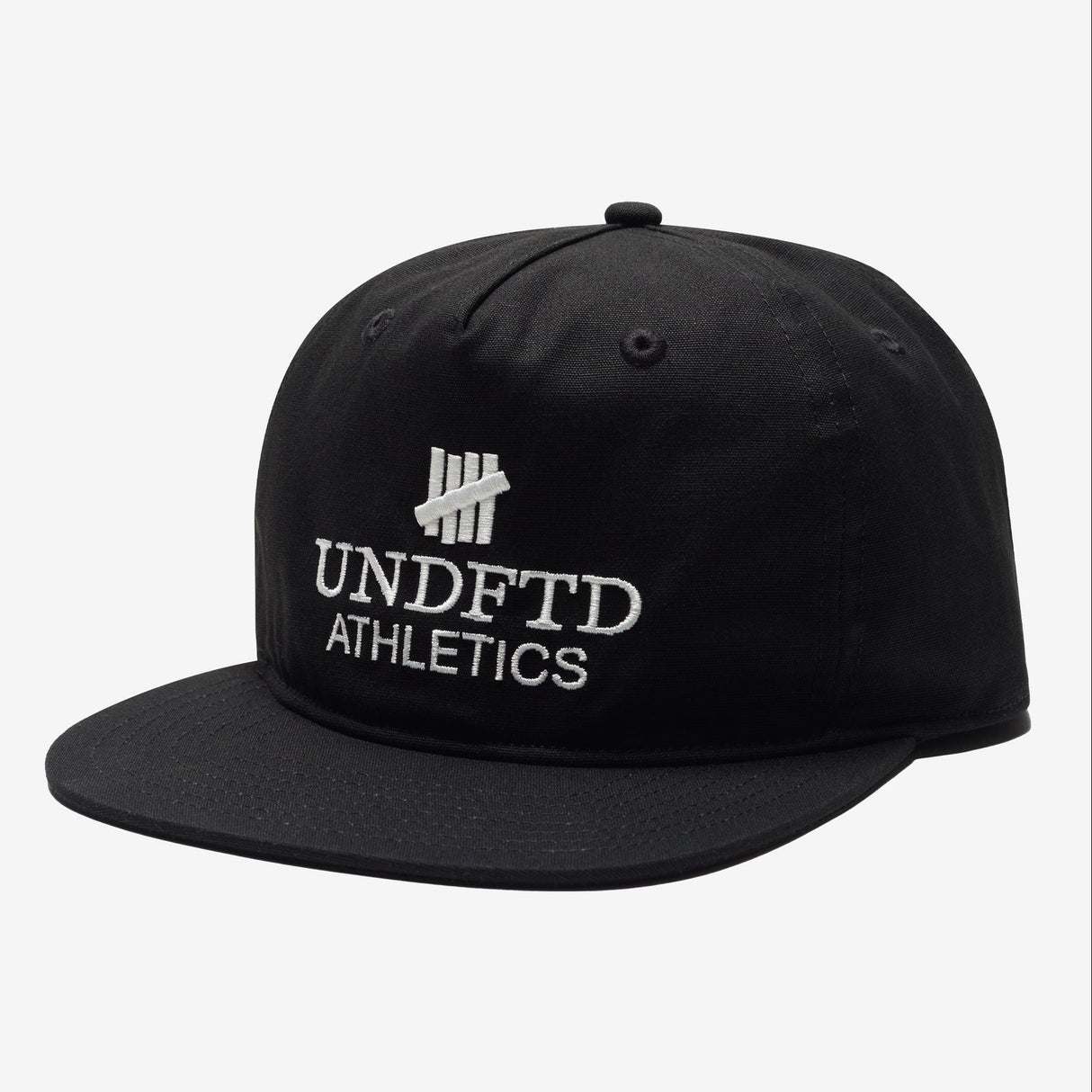 Black UNDEFEATED logo snapback hat, athletic-style headwear with adjustable strap and flat brim, front embroidered logo.