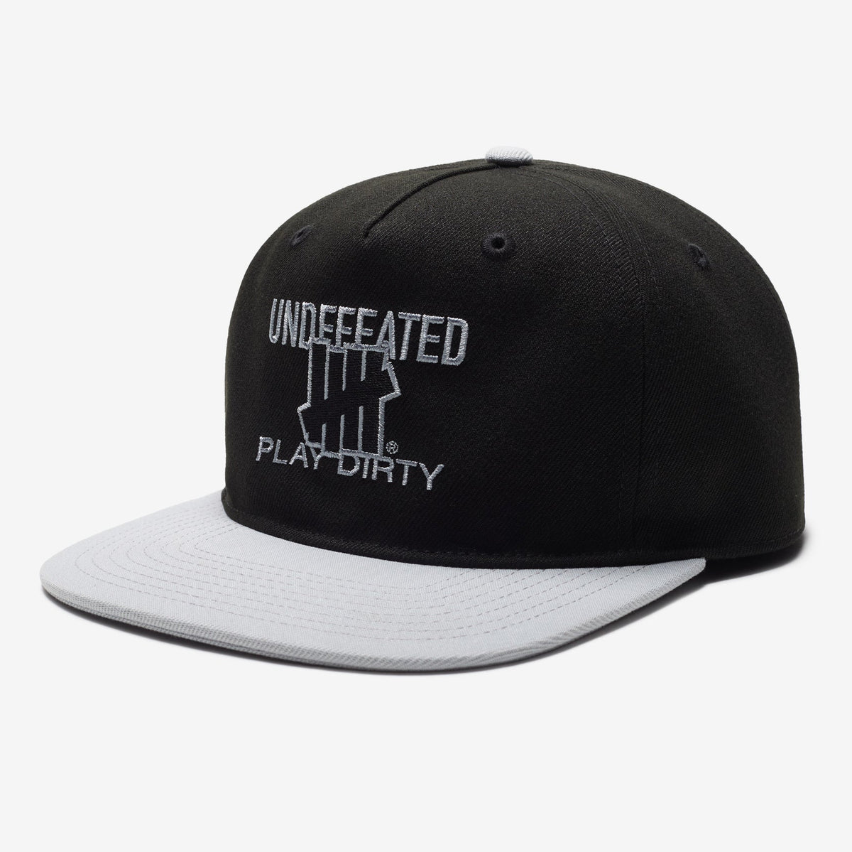 Black Undefeated Play Dirty snapback hat featuring bold branding and adjustable strap, styled as casual headwear.
