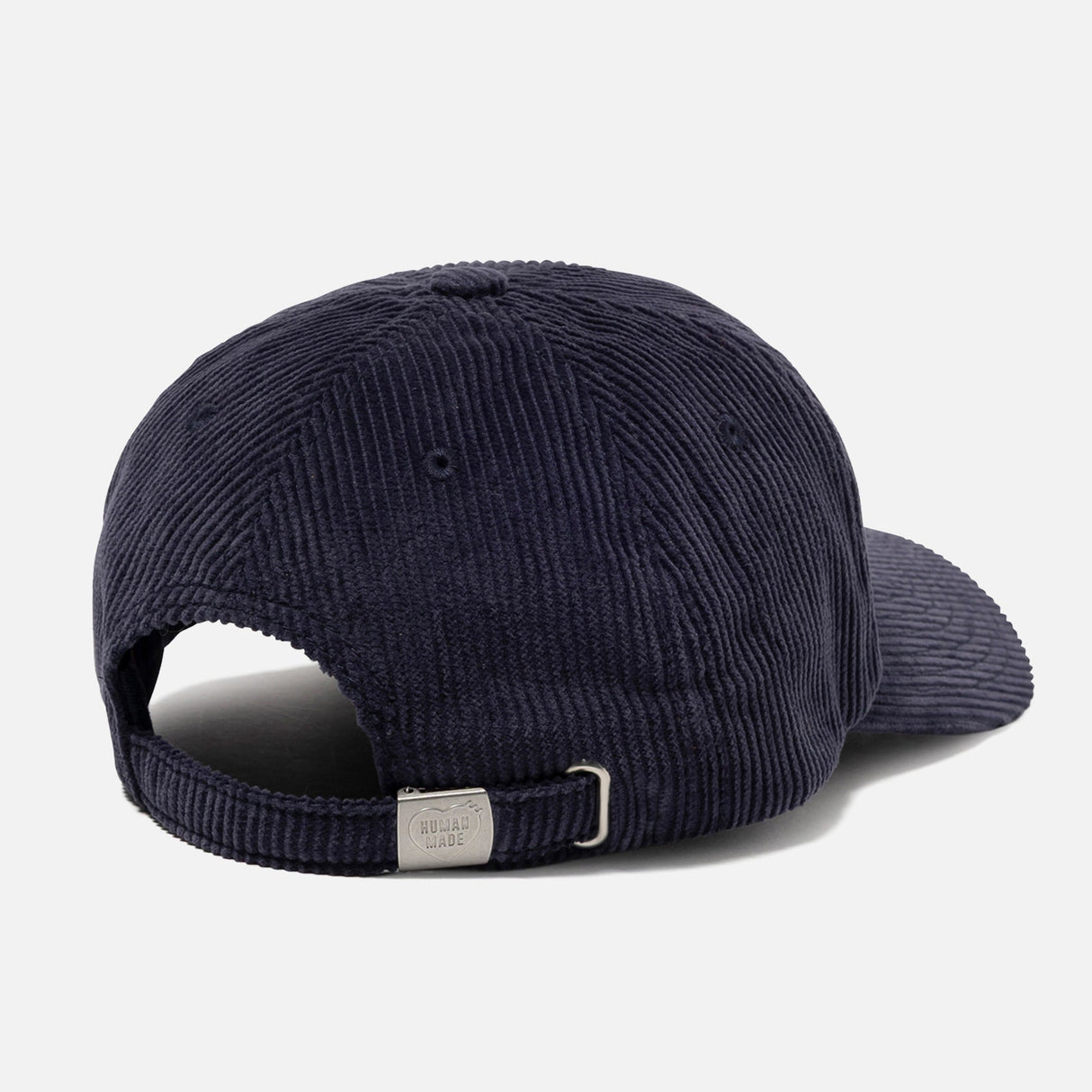 Human Made navy corduroy cap featuring a heart logo, casual headwear style with adjustable strap and branded details.