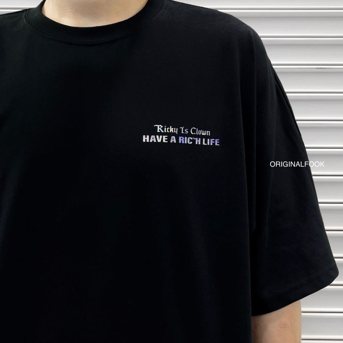 Black Rickyisclown holographic gothic drop shoulder tee featuring a relaxed fit and bold, reflective design.