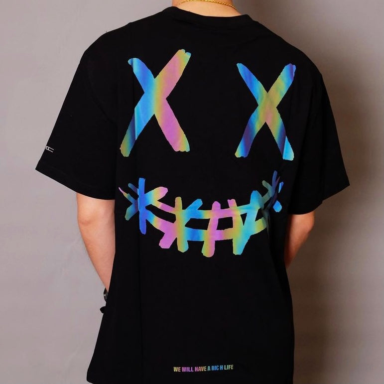 Black Rickyisclown Basic Reflective Smiley T-shirt featuring a bright, reflective smiley face design on the front.