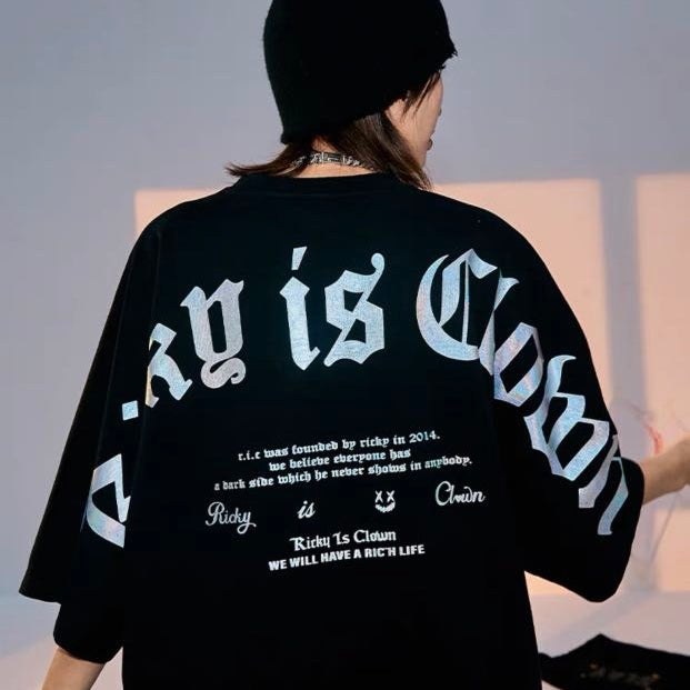 Black Rickyisclown holographic gothic drop shoulder T-shirt with bold design and relaxed fit, featuring the RICKYISCLOWN brand logo.