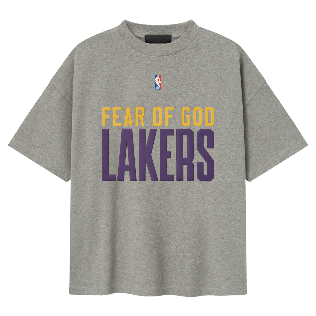 Fear of God Essentials X Lakers NBA 90s heavyweight tee in concrete, unisex apparel featuring Lakers logo and vintage-inspired design.