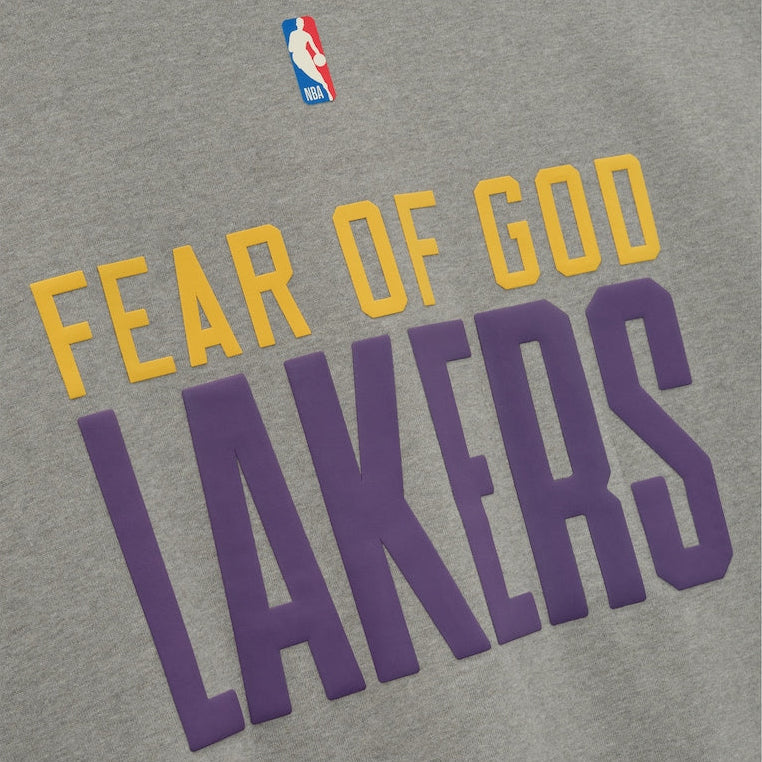 Fear of God Essentials Lakers NBA 90s heavyweight tee in concrete, unisex apprel featuring Los Angeles Lakers logo and vintage design.