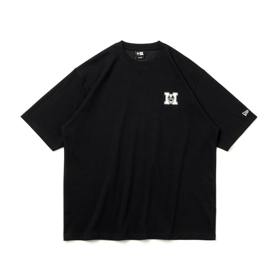 Black oversized T-shirt by MASTERMIND JAPAN and New Era with bold front logo, casual streetwear style, and comfortable fit.