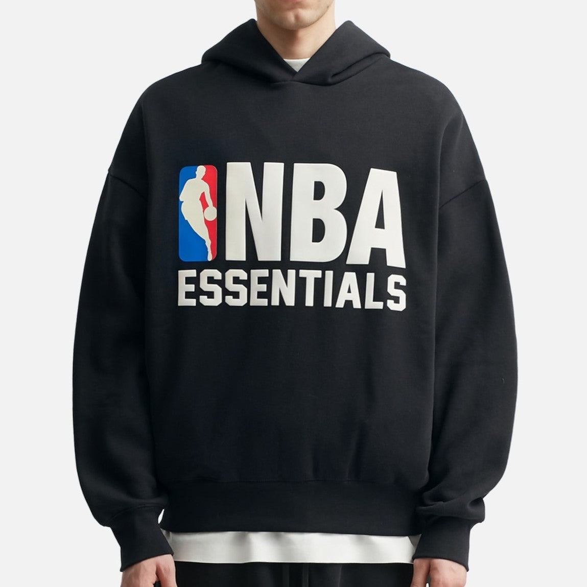 Black Fear of God Essentials NBA hoodie, casual apparel with sporty design and logo, displayed on a flat surface.