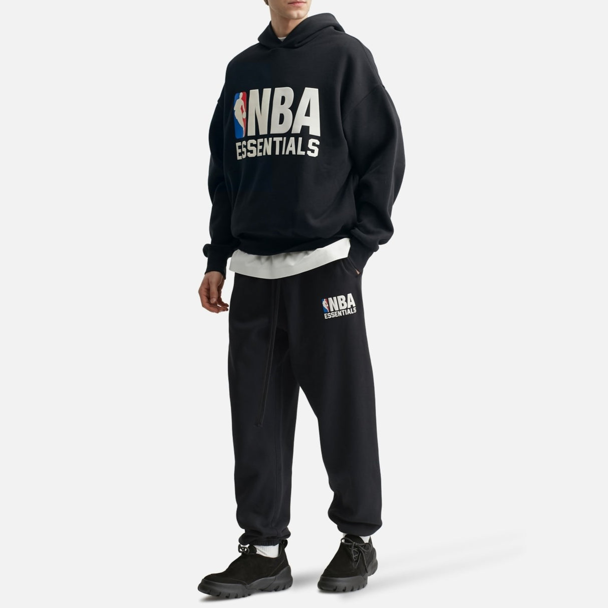 Black Fear of God Essentials NBA hoodie featuring the brand logo and athletic design, displayed on a white background.