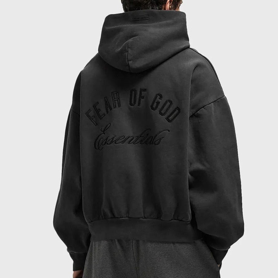 Fear of God Essentials Logo Classic Zip-up Hoodie in vintage black fabric, featuring a front zip and brand logo detail.