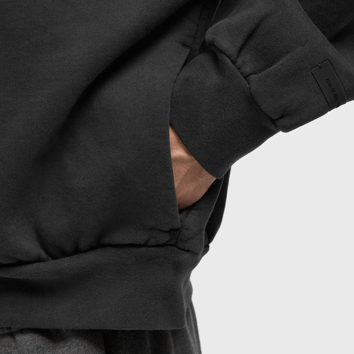 Fear Of God Essentials vintage black zip-up hoodie with logo, casual apparel featuring a classic design and front zipper.