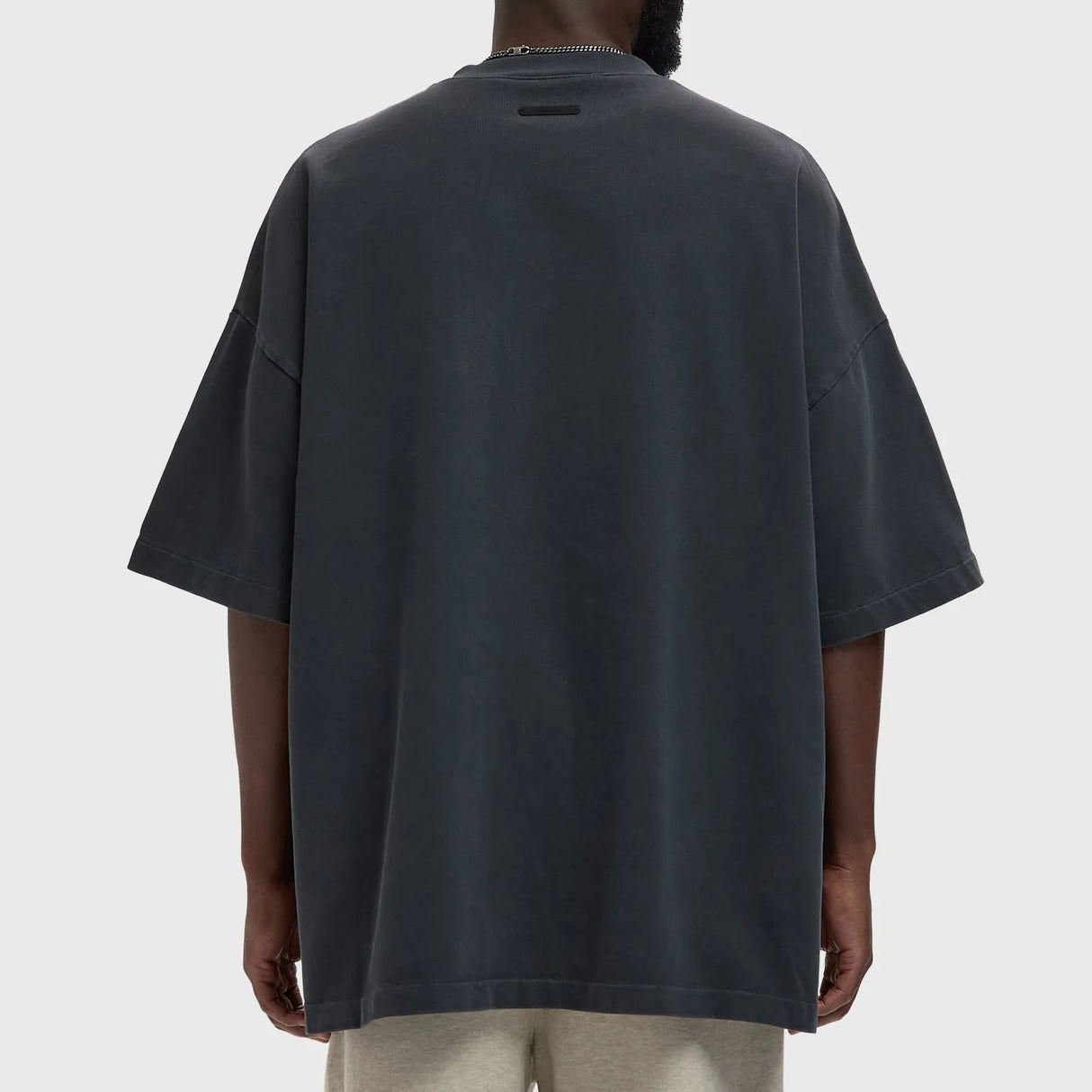 Fear of God Essentials Training 90s Heavyweight Tee in Iron Grey, showing the relaxed fit and soft heavyweight fabric.