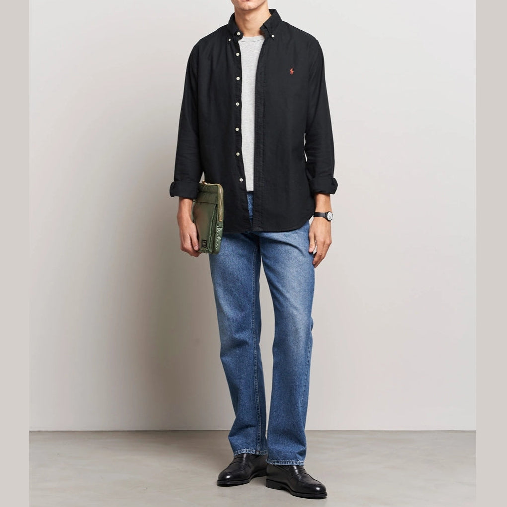 Black Polo Ralph Lauren Classic Fit Oxford long sleeve shirt displayed on a hanger, showcasing its button-down collar and tailored fit.