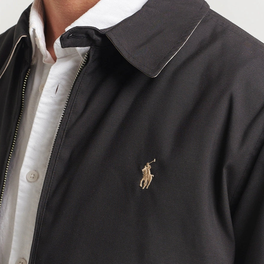 Black Polo Ralph Lauren Bi-Swing Harrington Jacket displayed on a hanger, showing the classic style and detailed design features.