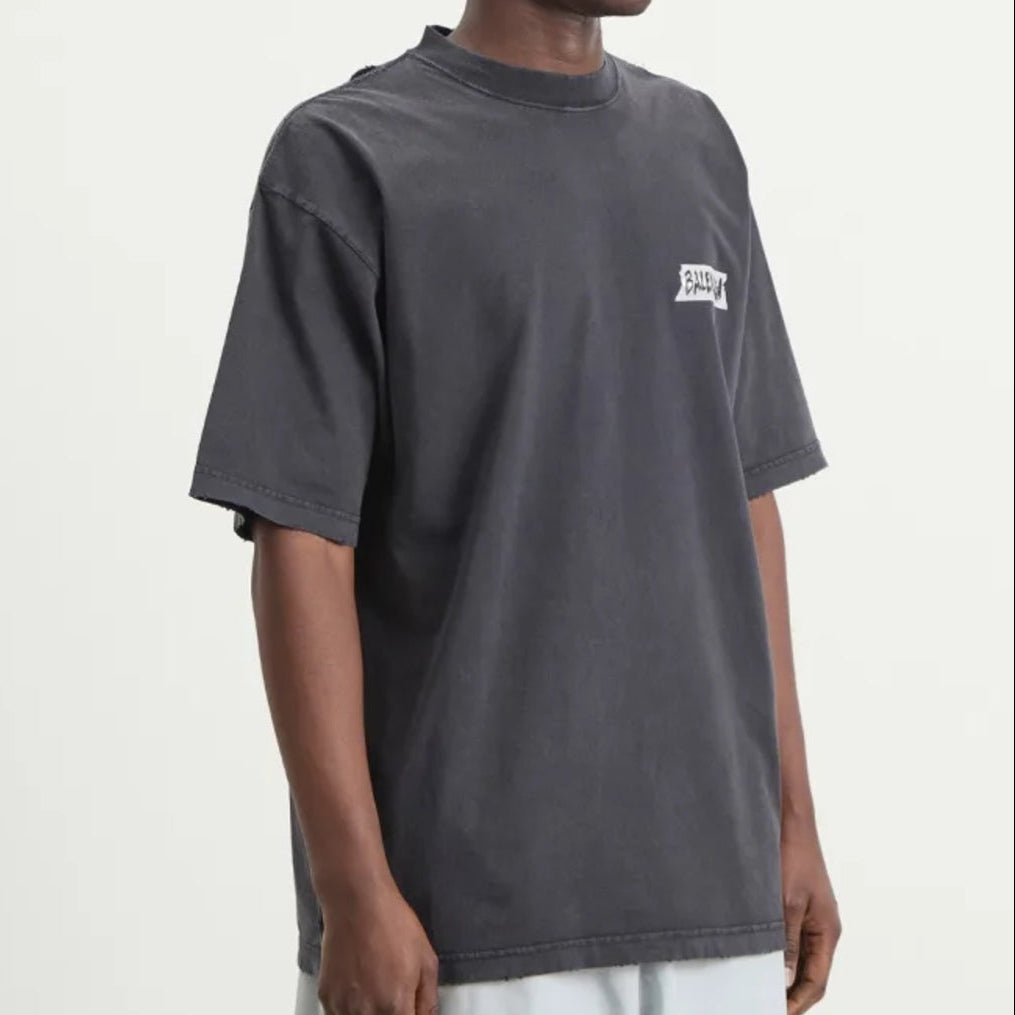 Balenciaga Masking Tape Tee in black, featuring a casual crew neck design and graphic print, styled on a model.