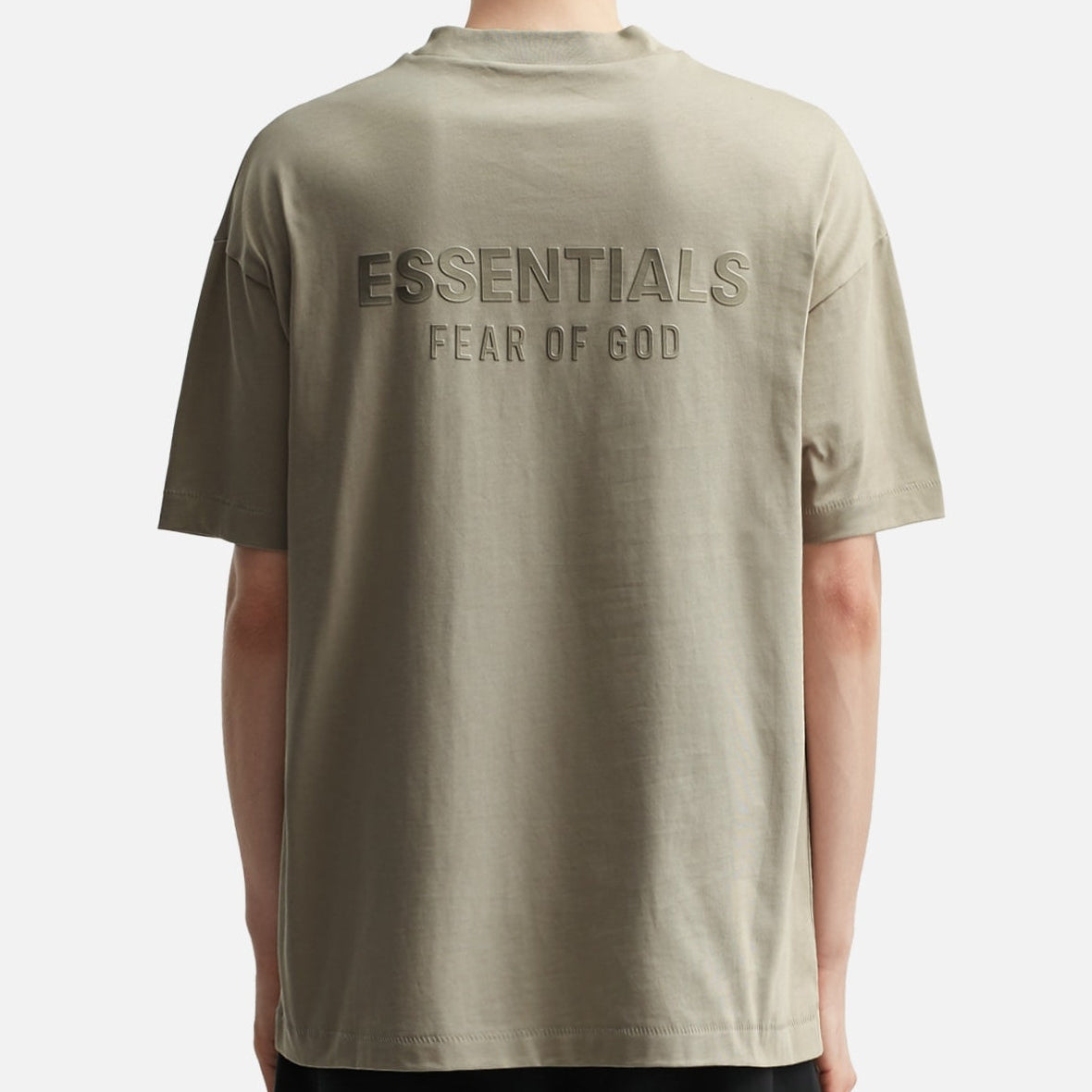 Fear of God Essentials metallic logo classic fit tee in Abbey Stone, showing the soft fabric and subtle logo detail.