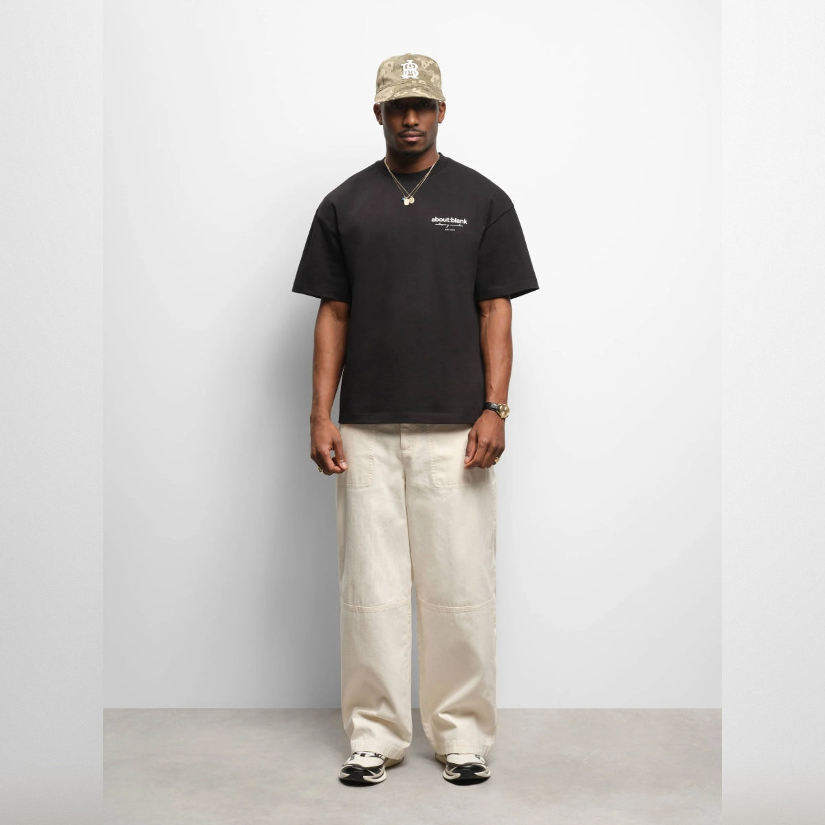 Black AboutBlank Reverse Blank Tee shirt displayed flat, showcasing its simple, classic design and smooth fabric texture.
