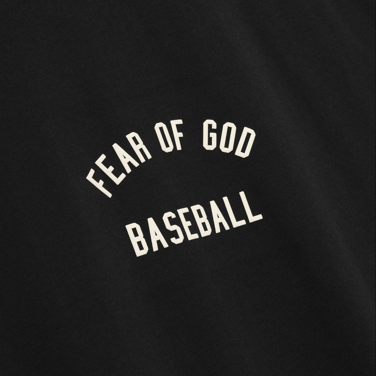 Fear of God Essentials MLB 90s Tee, casual apparel with graphic design, featuring the FEAR OF GOD ESSENTIALS branding and MLB logo.