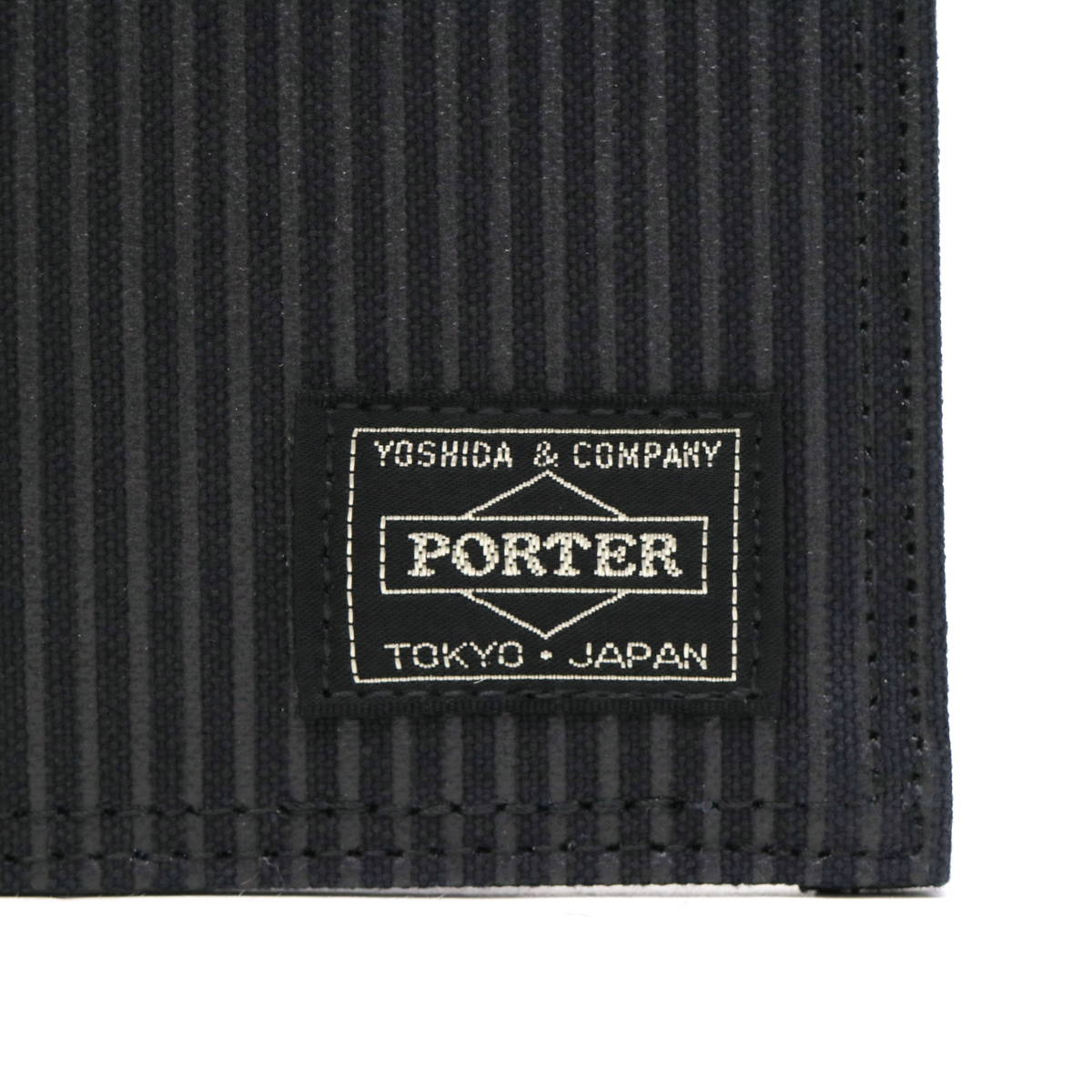 Black Porter Yoshida Japan Drawing Wallet from PORTER JAPAN, showcasing its sleek design and compact bag style.