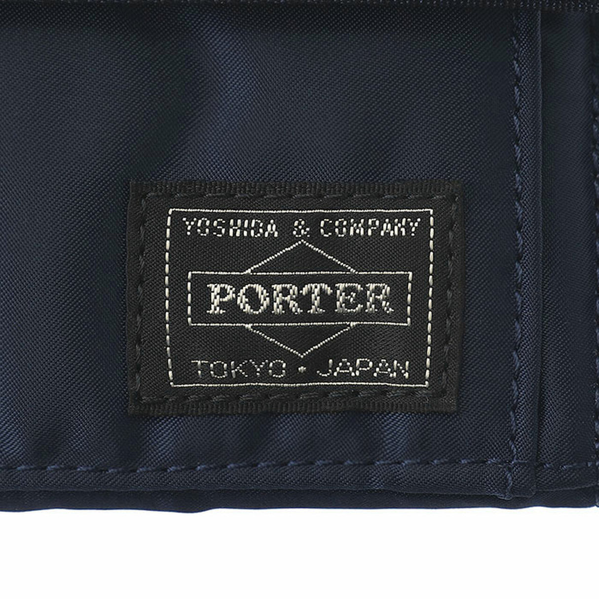 Porter Japan Tanker Two-Fold Wallet in iron blue with leather accents, featuring multiple card slots and a compact design.