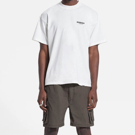 Dark taupe REPRESENT cargo shorts with multiple pockets and relaxed fit, shown on a model.