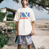 Cream Fear of God Essentials X NBA 90s Heavyweight Tee, casual crewneck shirt with NBA logo and vintage 90s design.