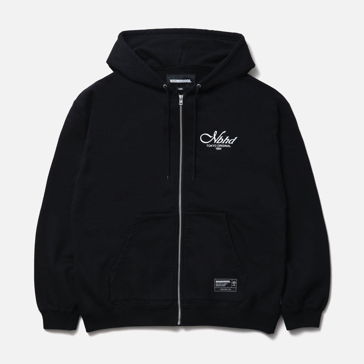Black Neighborhood Staple Zip Hoodie, casual streetwear with a front zipper and logo details, shown on a model.