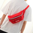 Supreme reflective waist bag in red with adjustable strap and logo, designed for style and practicality.
