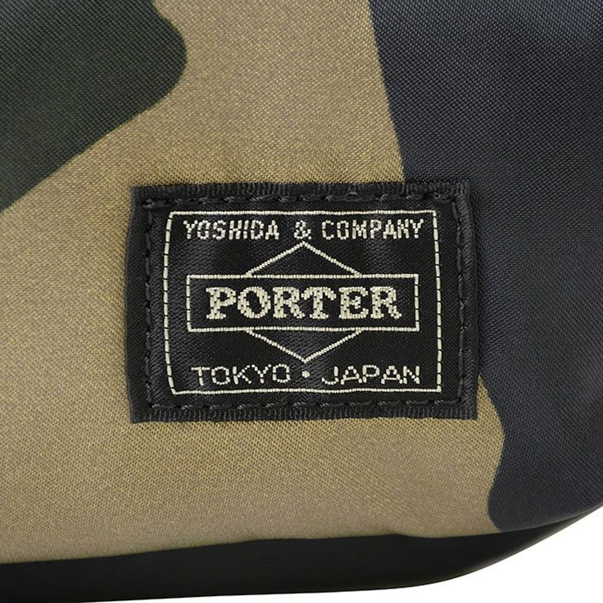 Porter Yoshida Japan Counter Shade large waist bag in camouflage with adjustable strap and multiple compartments.
