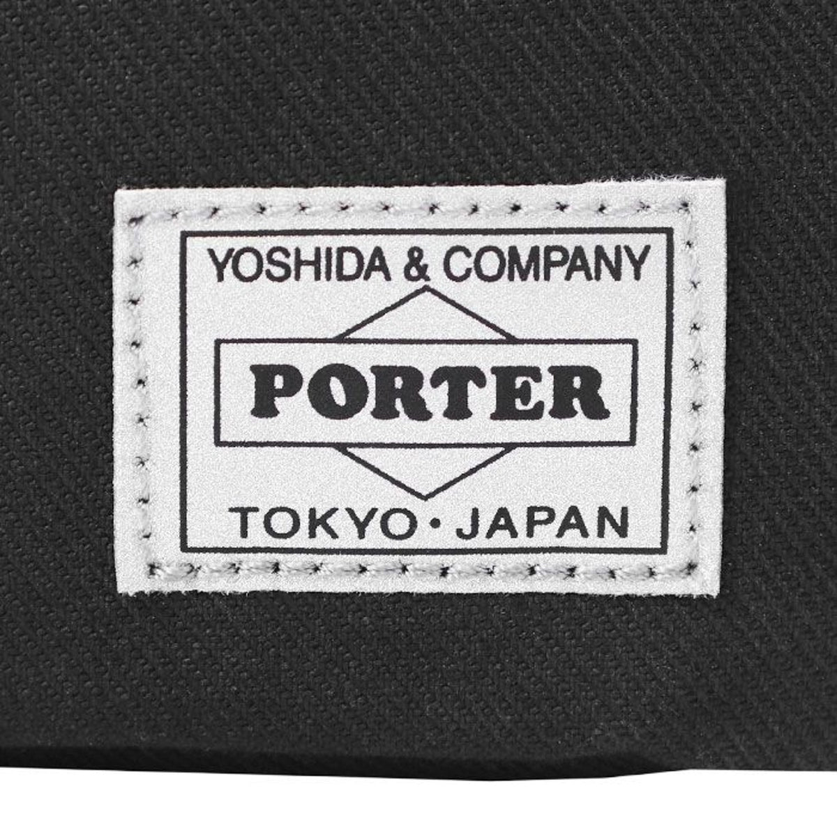 Porter Yoshida Japan Switch large shoulder bag with adjustable strap and multiple compartments, made of durable fabric.