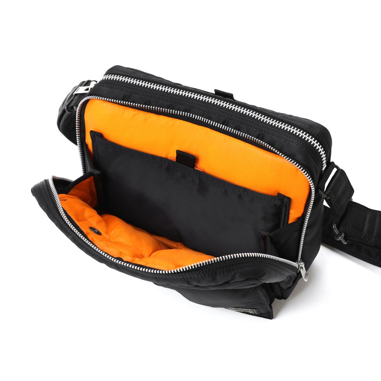 Black Porter Yoshida Japan Tanker Sling Bag with adjustable strap and multiple compartments, stylish and functional for everyday use.