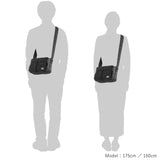 Porter Yoshida Japan Tanker Zip Sling Bag in black with adjustable strap and multiple compartments, designed for versatile carrying.