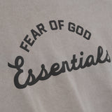 Fear of God Essentials Training 90s heavyweight short sleeve tee in faded dune color, displayed on a flat lay with a minimalist background.