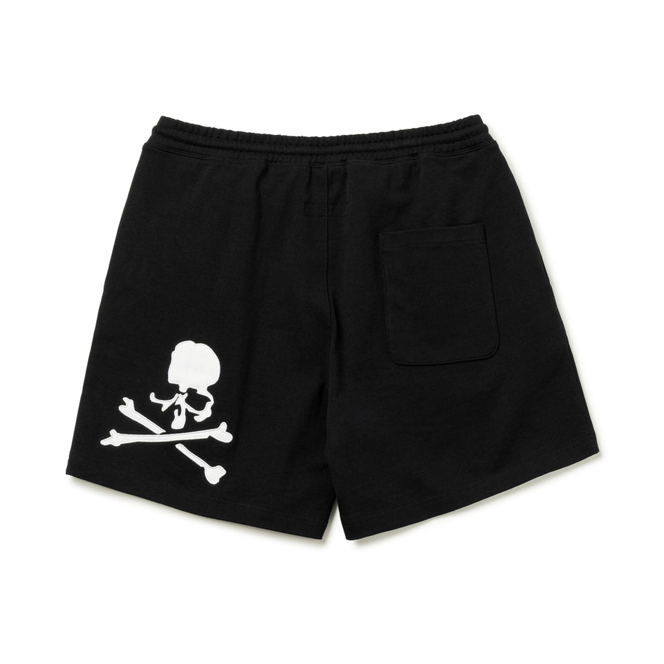 Black Mastermind Japan X New Era script logo shorts featuring bold branding and casual design, perfect for streetwear style.