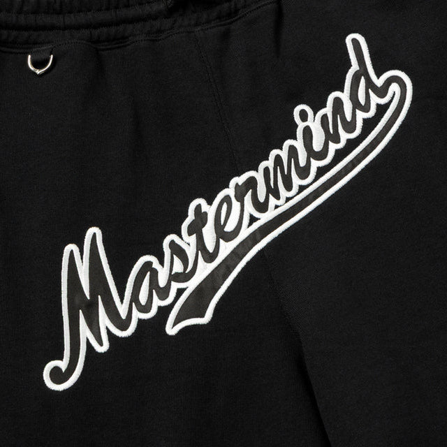 Black Mastermind Japan X New Era script logo shorts, casual apparel with bold branding and comfortable fit.