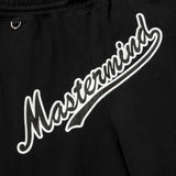 Black Mastermind Japan X New Era script logo shorts, casual apparel with bold branding and comfortable fit.
