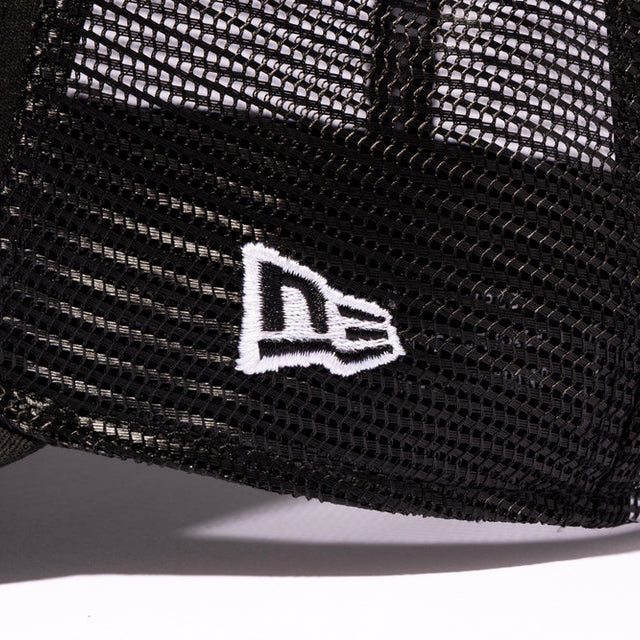 Black Mastermind Japan X New Era trucker cap with logo embroidery, adjustable mesh back, and classic curved brim.