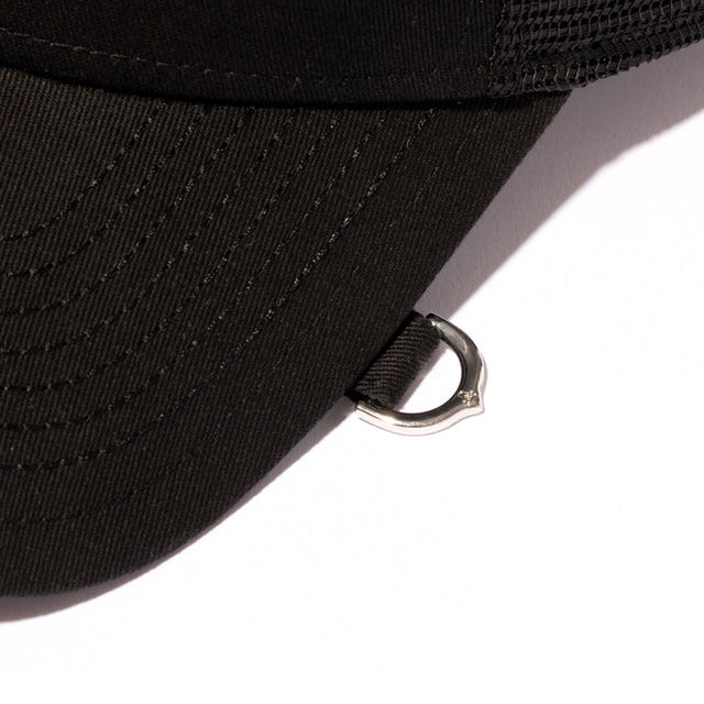 Black Mastermind Japan X New Era trucker cap with logo embroidery, adjustable snapback, and mesh back for ventilation.