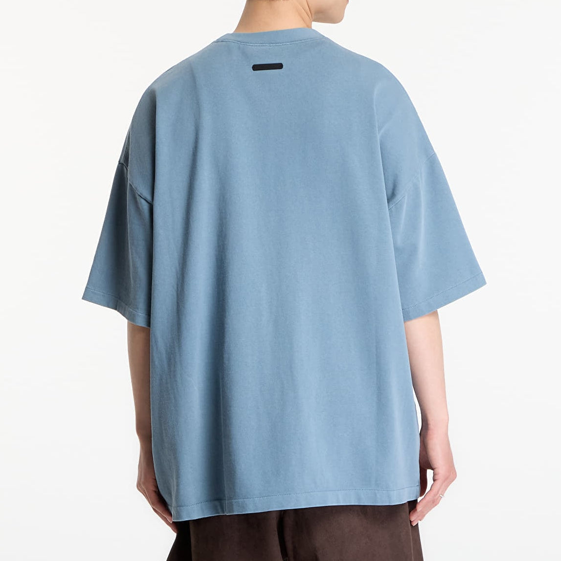 Fear of God Essentials Campus 90s Heavyweight Tee in faded coastal color, showing the relaxed fit and textured fabric.