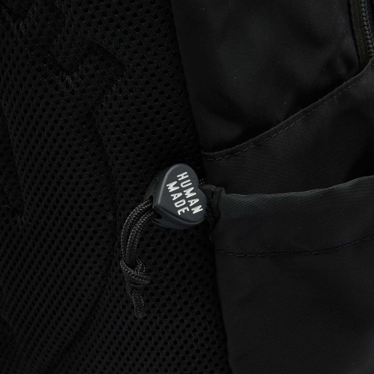 Black Human Made Military Backpack with multiple compartments and adjustable straps, designed for durability and style.