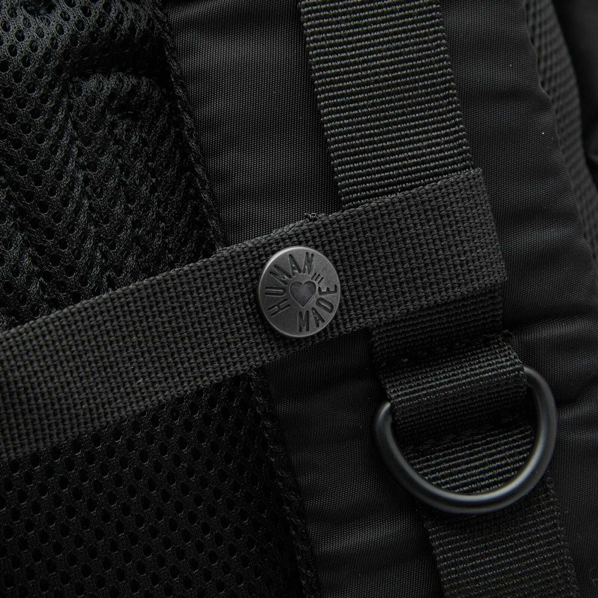 Black Human Made Military Backpack with multiple compartments and sturdy straps, designed for durability and style.