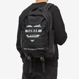 Black Human Made Military Backpack with multiple compartments, adjustable straps, and durable fabric for outdoor and urban use.