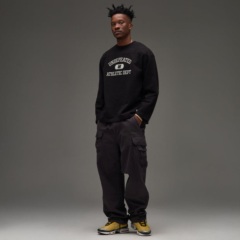 Black UNDEFEATED Undefeated Utility Pant with multiple pockets and relaxed fit, shown on a model.
