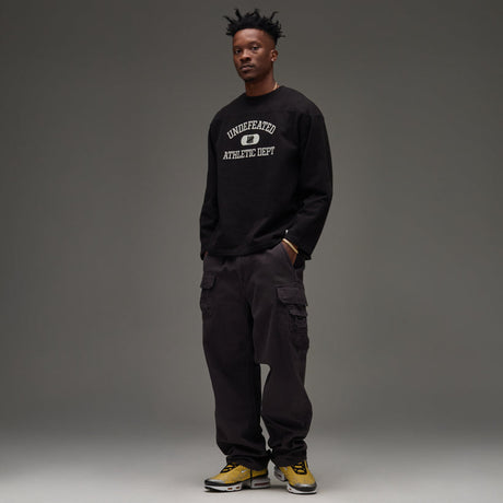 Black UNDEFEATED Undefeated Utility Pant with multiple pockets and relaxed fit, shown on a model.