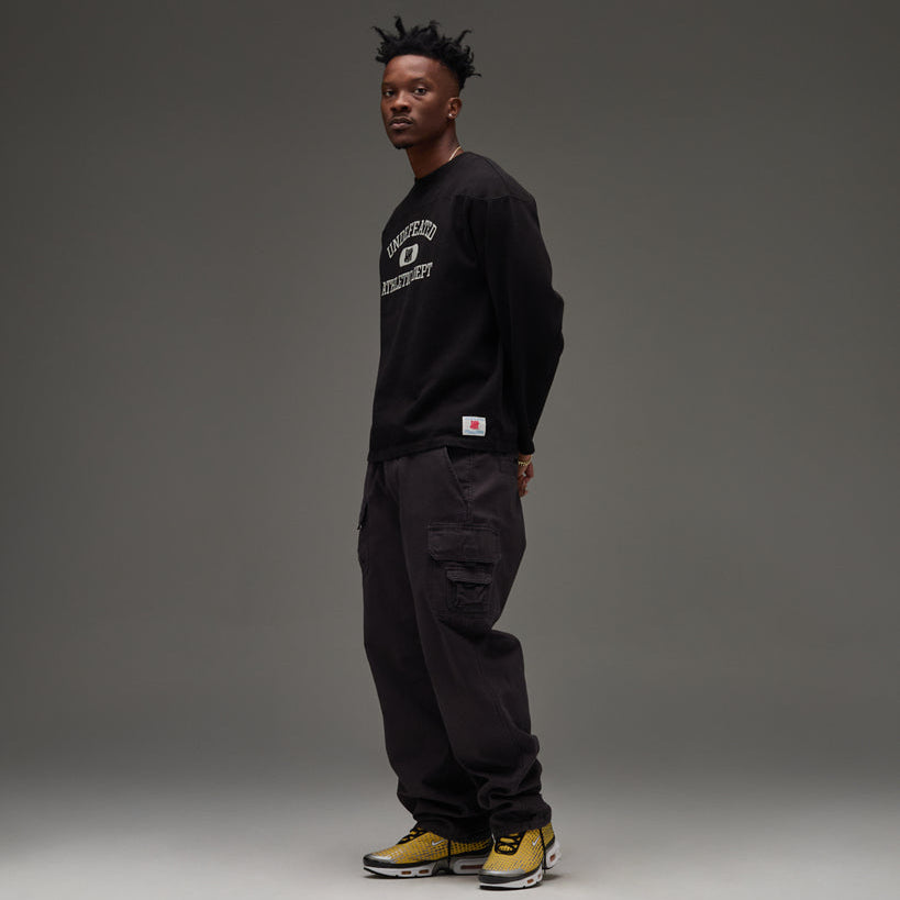 Black Undefeated Utility Pant with multiple pockets and relaxed fit, featuring durable fabric and streetwear style.