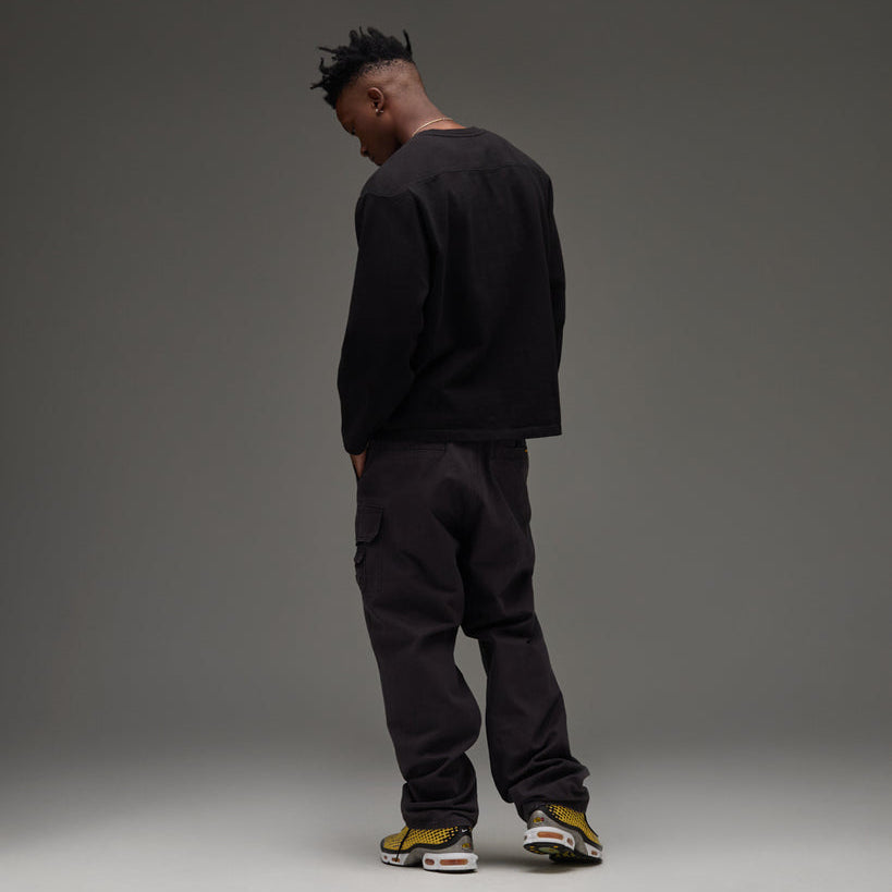Black Undefeated Utility Pant with multiple pockets and relaxed fit, designed for comfort and style.